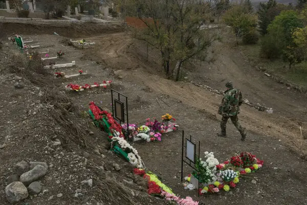 An Armenian soldier at the military cemetery in Stepanakert, in Nagorno-Karabakh, near the graves of fallen comrades who died this fall during clashes with Azerbaijani troops.