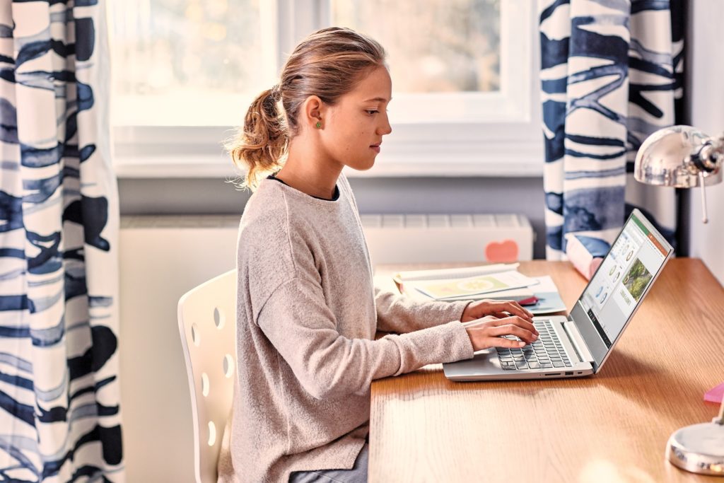 a girl with a laptop at home